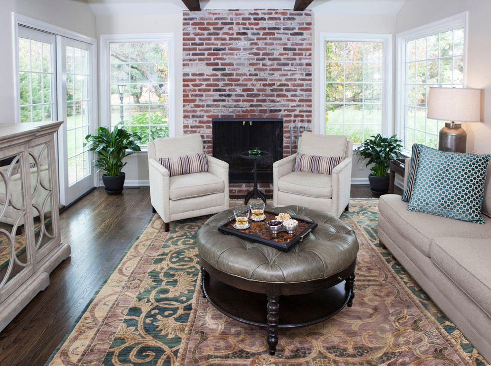 Inspiration for a medium sized classic enclosed games room in Philadelphia with beige walls, dark hardwood flooring, a standard fireplace, a brick fireplace surround and a freestanding tv.