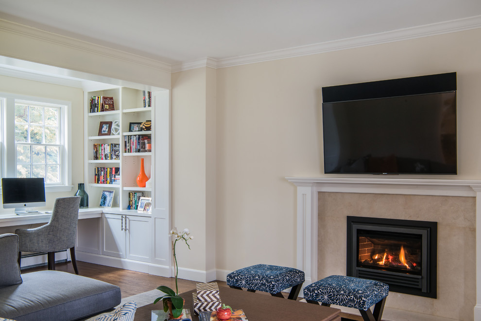Photo of a medium sized traditional games room in Boston with yellow walls, medium hardwood flooring, a standard fireplace, a wall mounted tv, brown floors and a stone fireplace surround.