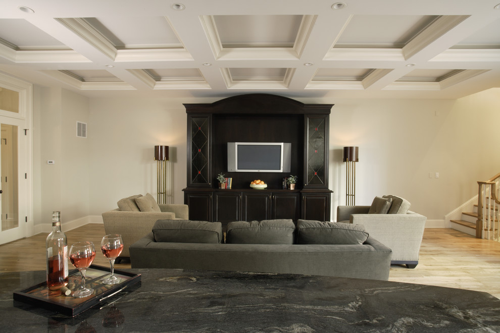Imagen de sala de estar cerrada clásica grande con paredes beige, suelo de madera clara y pared multimedia