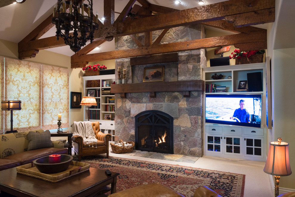 Large traditional open plan games room in Sacramento with beige walls, dark hardwood flooring, a standard fireplace, a stone fireplace surround, a built-in media unit and brown floors.