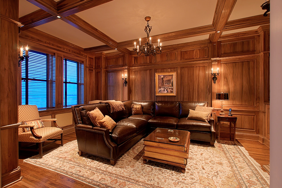 Family room library - mid-sized transitional enclosed medium tone wood floor and brown floor family room library idea in Chicago with brown walls and a concealed tv