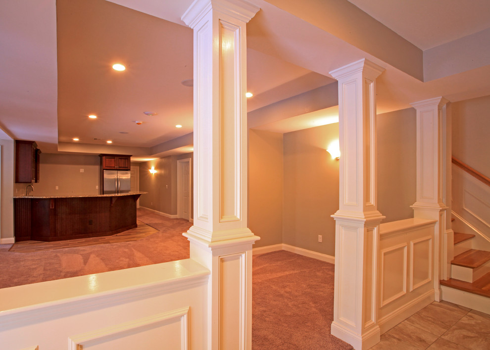 This is an example of a large traditional enclosed games room in Providence with a home bar, beige walls and carpet.