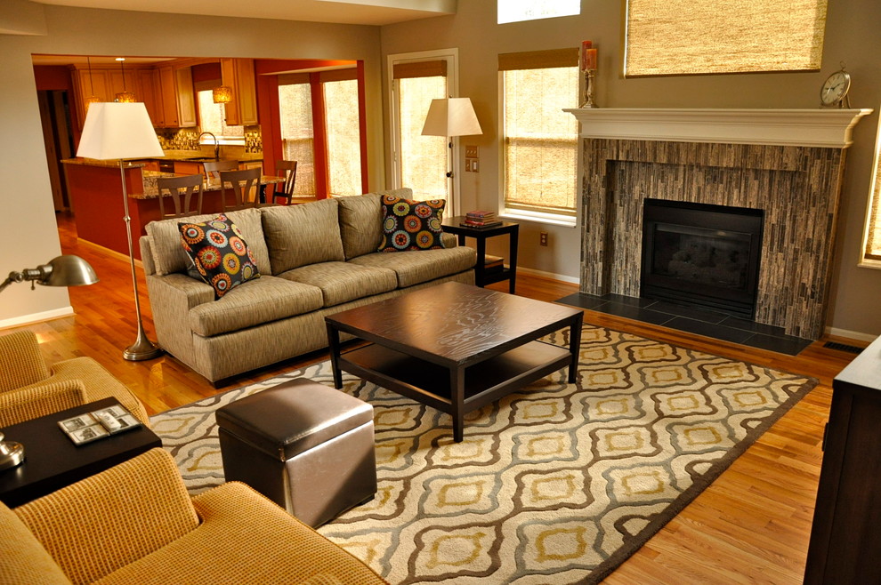 Photo of a medium sized traditional open plan games room in Cincinnati with grey walls, light hardwood flooring, a standard fireplace, a tiled fireplace surround and a freestanding tv.