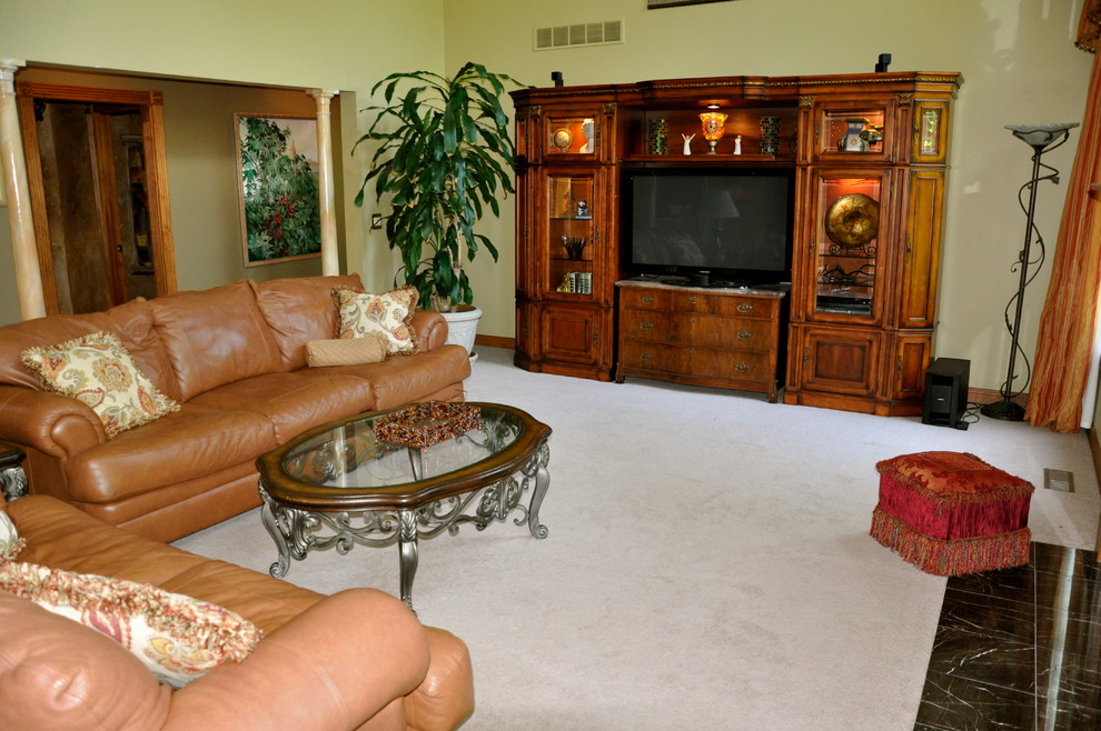 This is an example of a medium sized classic mezzanine games room in Cincinnati with green walls, carpet, a standard fireplace, a tiled fireplace surround and a freestanding tv.