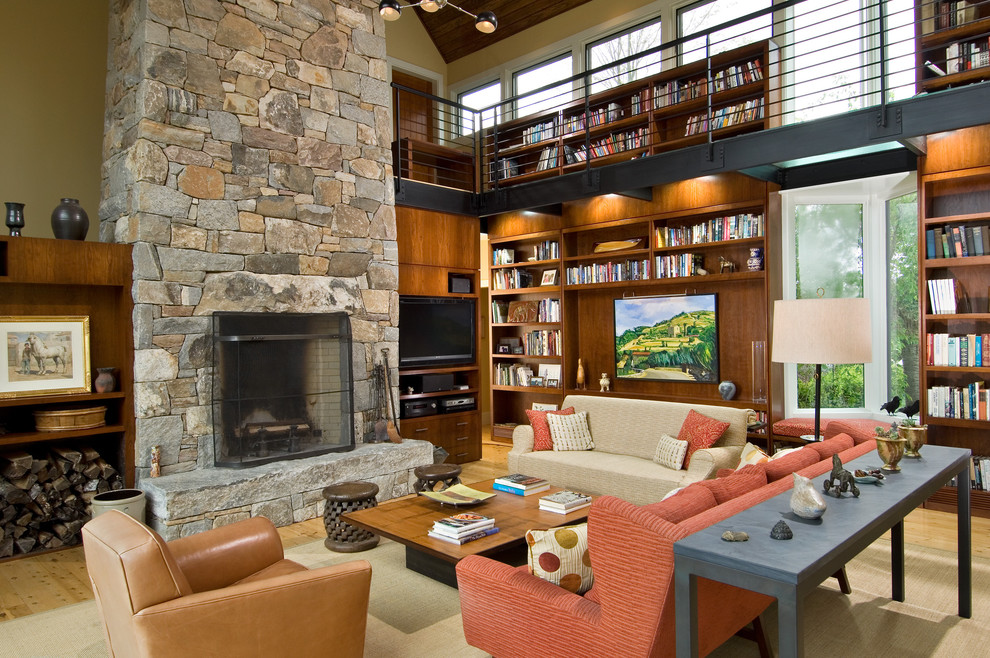 Contemporary open plan games room in Boston with beige walls, a standard fireplace, a stone fireplace surround and a built-in media unit.