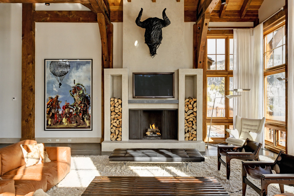 Example of a southwest open concept dark wood floor family room design in New York with beige walls, a standard fireplace and a wall-mounted tv