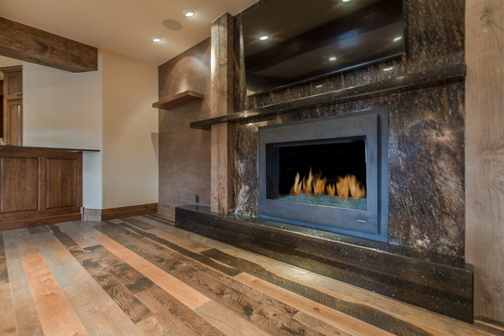 Example of a mid-sized danish open concept medium tone wood floor family room design in Denver with beige walls, a standard fireplace and a wall-mounted tv