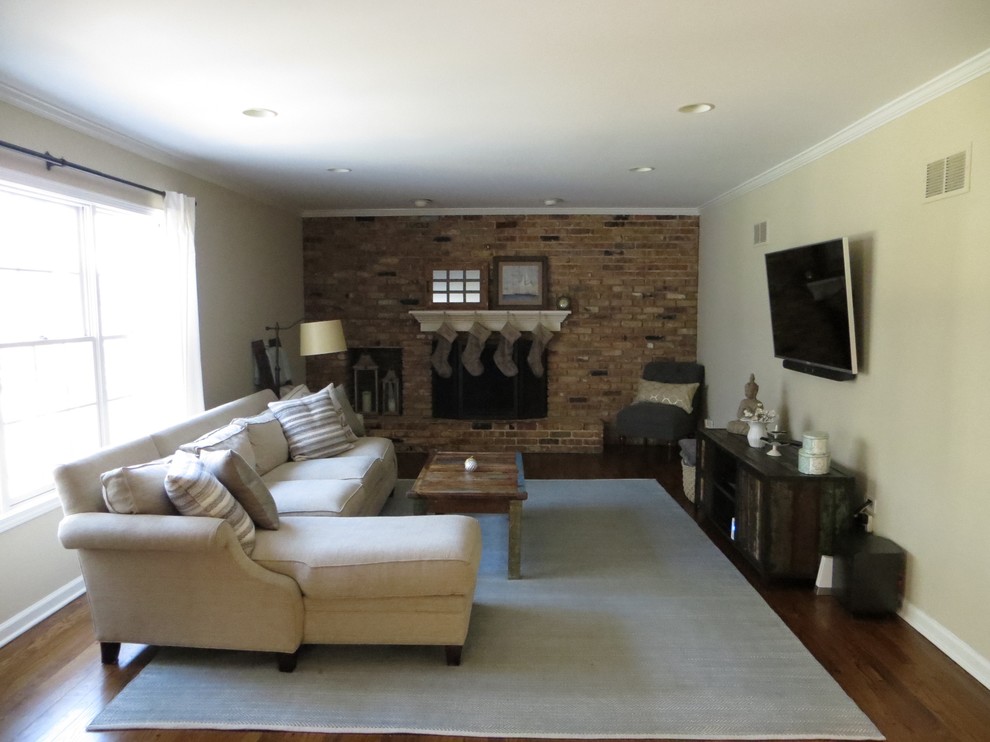 This is an example of a large farmhouse games room in Chicago with beige walls, dark hardwood flooring, a standard fireplace and a brick fireplace surround.