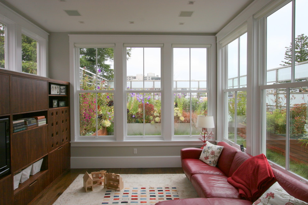 Inspiration for a contemporary family room remodel in San Francisco with beige walls and a media wall