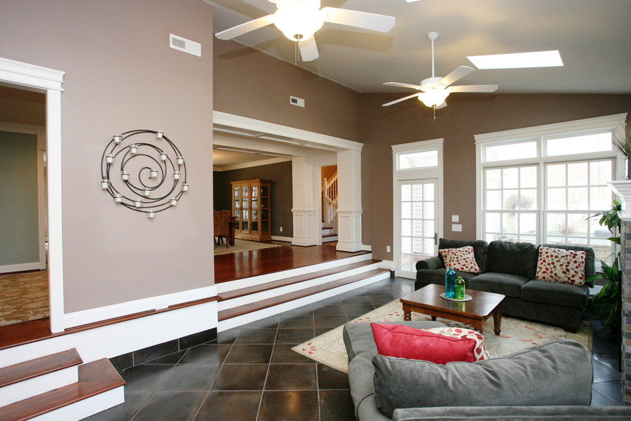 Medium sized classic open plan games room in Raleigh with beige walls, slate flooring and a standard fireplace.