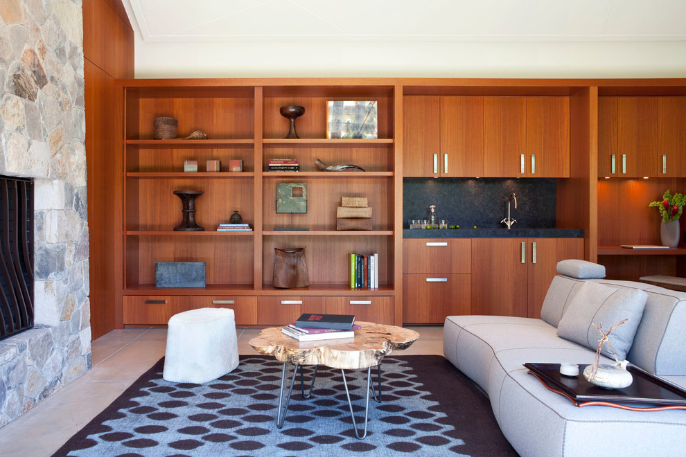 Ejemplo de sala de estar contemporánea grande con marco de chimenea de piedra, paredes marrones, todas las chimeneas y alfombra