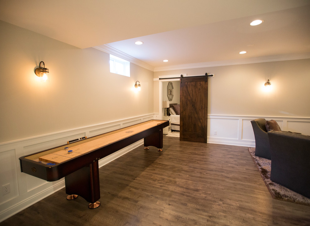 Large transitional open concept vinyl floor and brown floor game room photo in Chicago with beige walls, no fireplace and a media wall