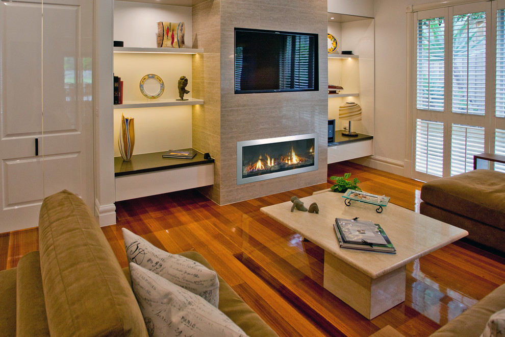 Large contemporary games room in Melbourne with white walls, a standard fireplace, a tiled fireplace surround and a built-in media unit.