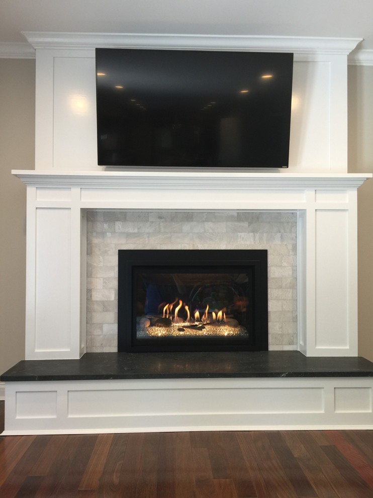 Large classic open plan games room in Cincinnati with grey walls, medium hardwood flooring, a standard fireplace and a stone fireplace surround.