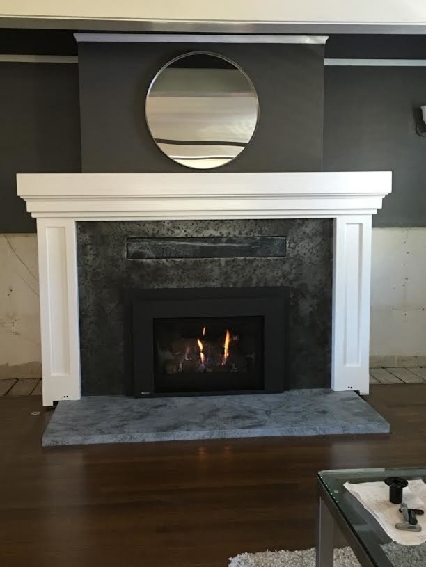 Mid-sized dark wood floor family room photo in San Diego with a standard fireplace, a metal fireplace and black walls
