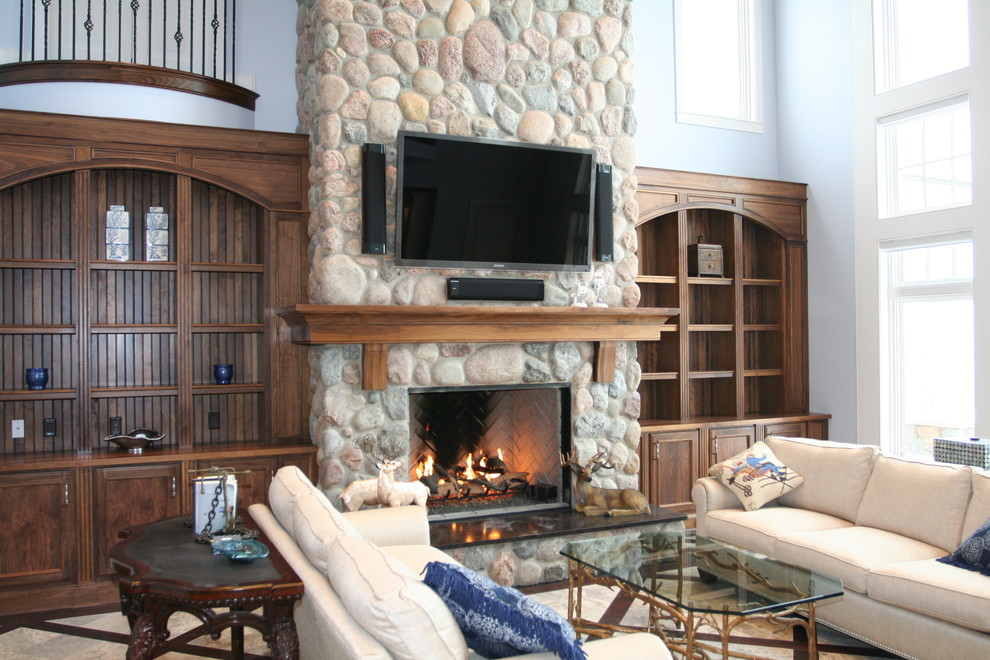 This is an example of an expansive rustic open plan games room in Other with blue walls, dark hardwood flooring, a standard fireplace, a stone fireplace surround and a wall mounted tv.