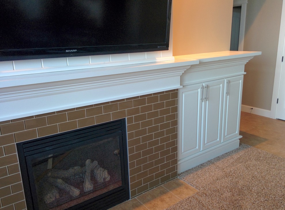Traditional games room in Seattle with carpet, a standard fireplace, a tiled fireplace surround and a wall mounted tv.