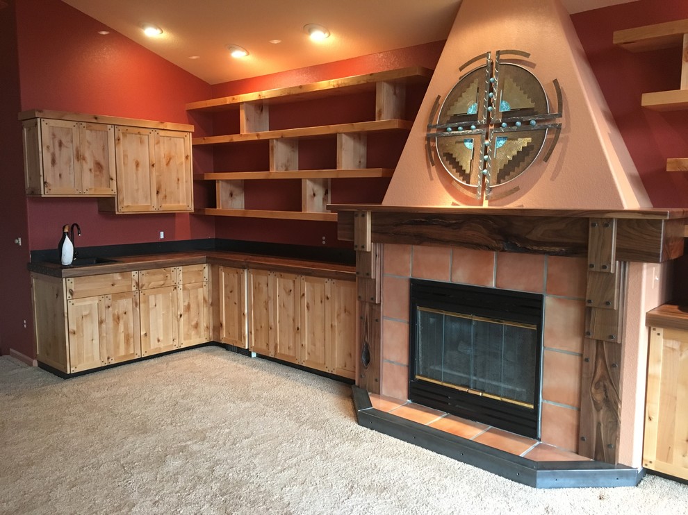 デンバーにあるお手頃価格の中くらいなラスティックスタイルのおしゃれなオープンリビング (ホームバー、赤い壁、カーペット敷き、標準型暖炉、タイルの暖炉まわり、据え置き型テレビ) の写真