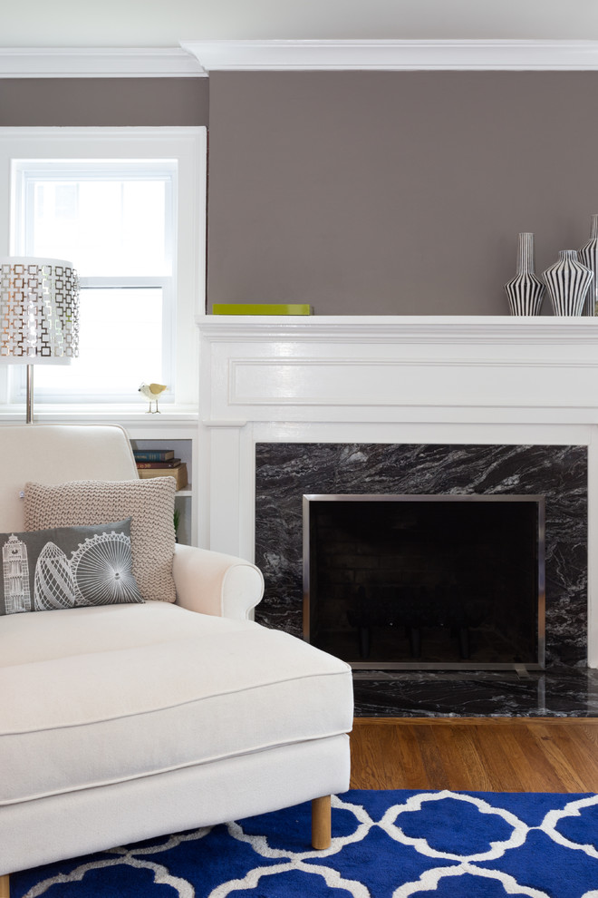 Medium sized classic games room in New York with grey walls, medium hardwood flooring, a standard fireplace, a stone fireplace surround and no tv.