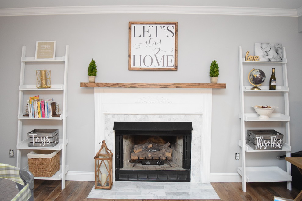 Inspiration for a large cottage medium tone wood floor and brown floor family room remodel in Wilmington with gray walls, a standard fireplace and a tile fireplace