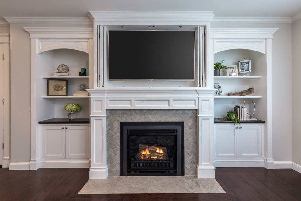 Inspiration for a mid-sized timeless enclosed dark wood floor and brown floor family room library remodel in San Francisco with gray walls, a standard fireplace, a tile fireplace and a concealed tv