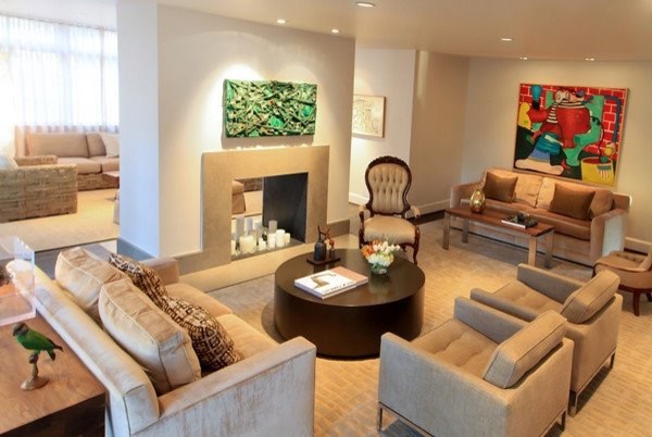 Ejemplo de sala de estar con barra de bar cerrada de tamaño medio con paredes blancas, suelo de madera oscura, chimenea de doble cara y marco de chimenea de piedra