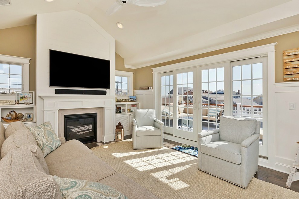 Example of a mid-sized beach style open concept dark wood floor family room design in New York with multicolored walls, a standard fireplace, a tile fireplace and a wall-mounted tv
