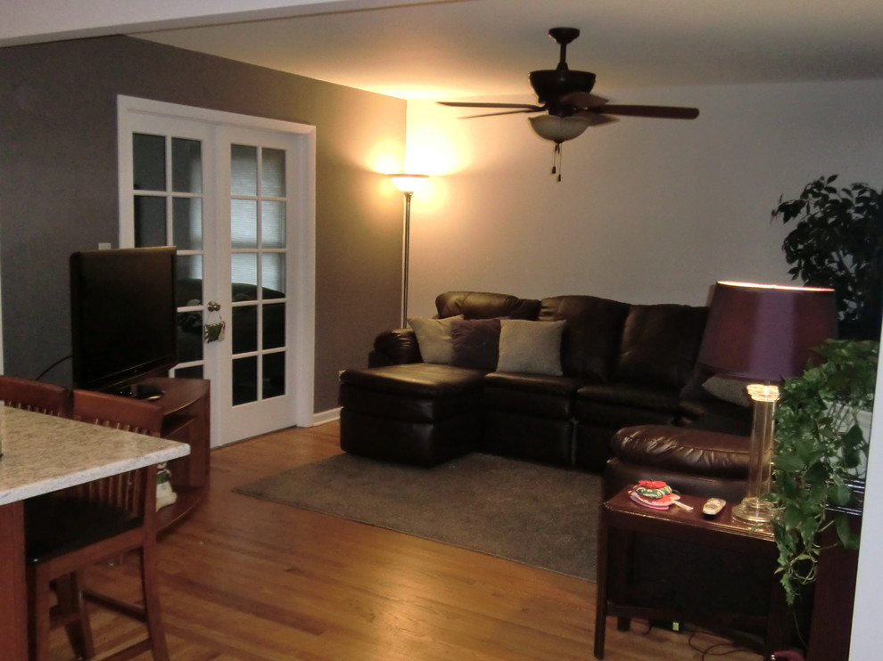 Diseño de sala de estar abierta clásica grande con paredes grises y suelo de madera en tonos medios