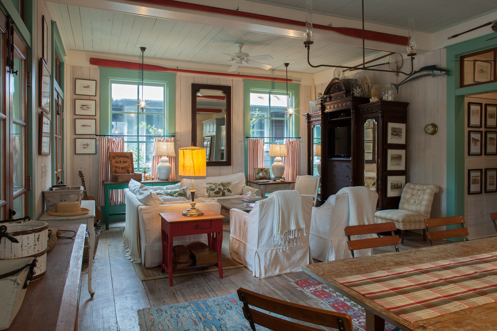Example of a beach style open concept light wood floor family room design in Miami with beige walls