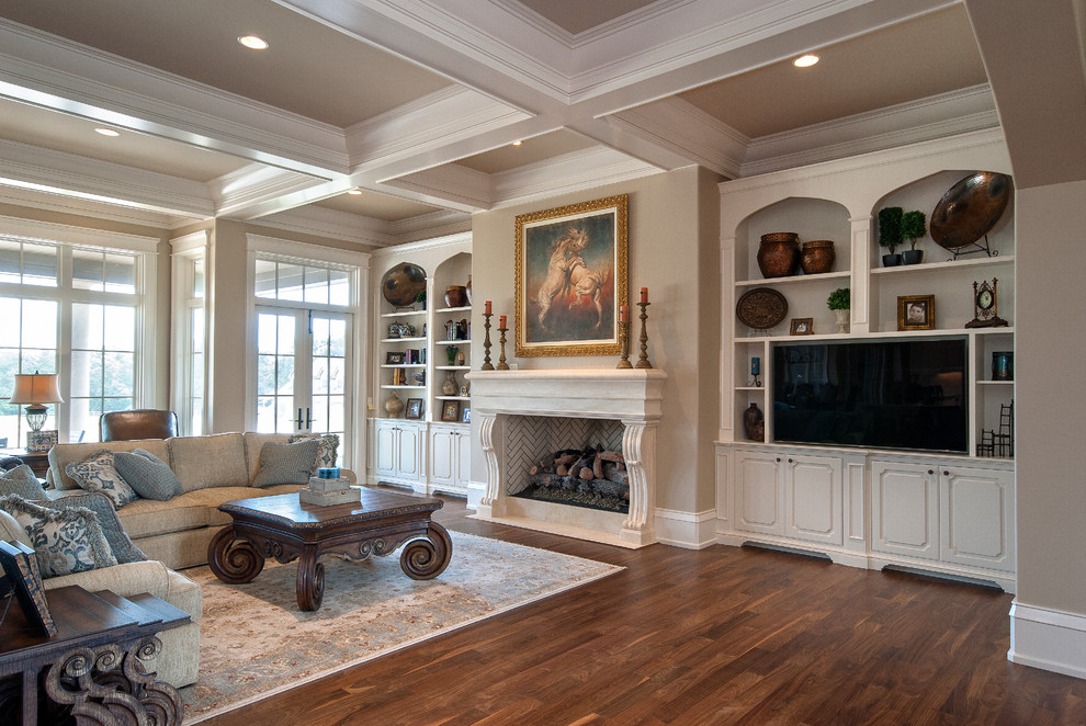 This is an example of an expansive classic open plan games room in Other with beige walls, dark hardwood flooring, a standard fireplace, a stone fireplace surround and a built-in media unit.