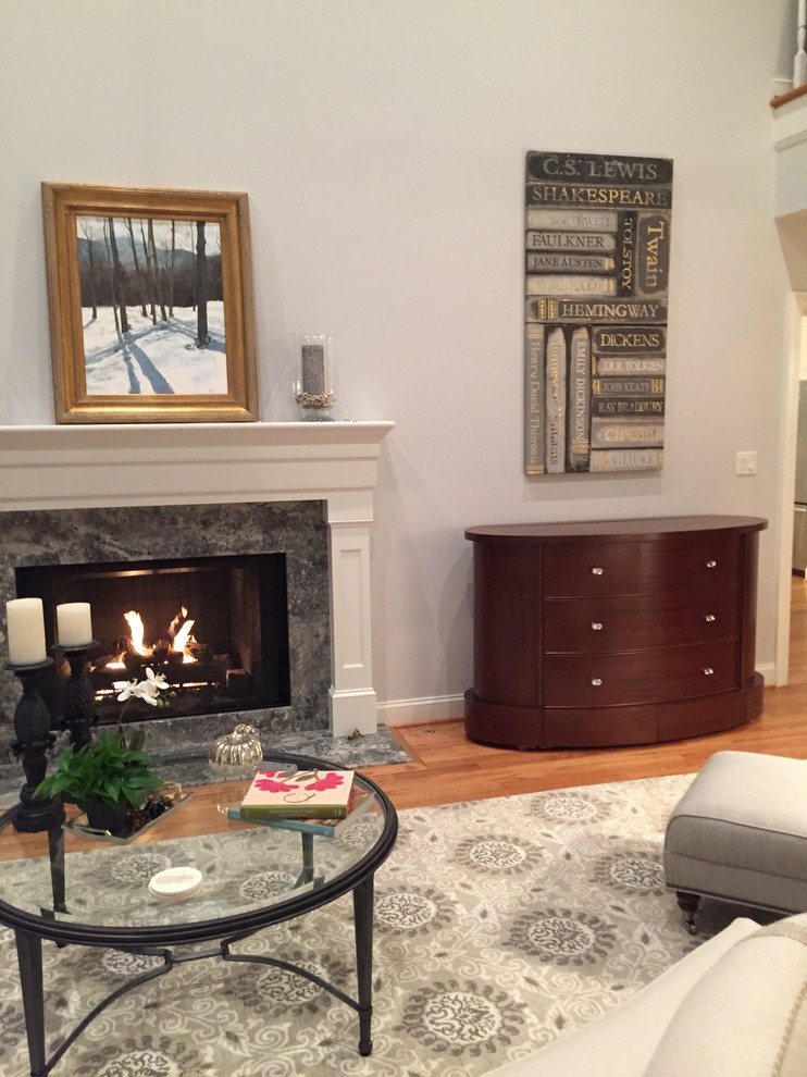 Photo of a medium sized classic enclosed games room in New York with a standard fireplace, a wooden fireplace surround and a concealed tv.