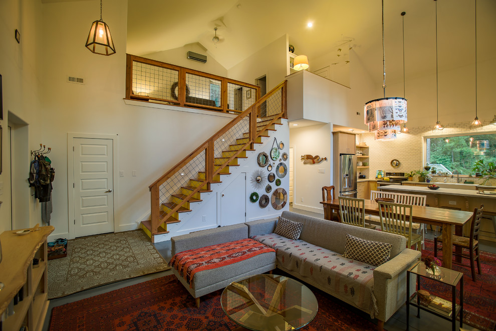 Esempio di un piccolo soggiorno country stile loft con pareti beige, pavimento in cemento, nessun camino e TV autoportante