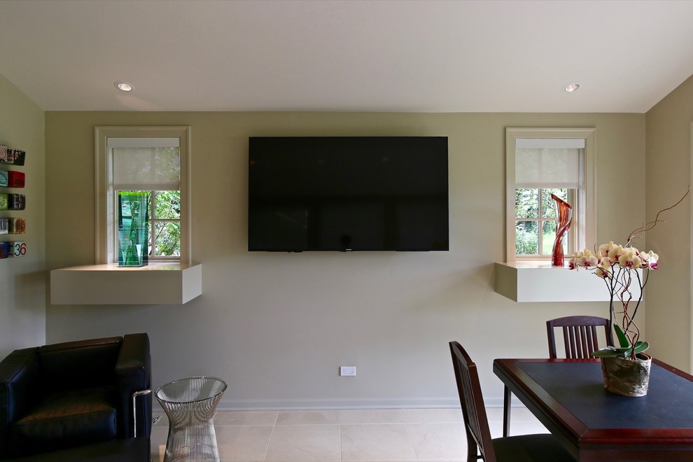 Modelo de sala de estar abierta minimalista pequeña sin chimenea con paredes beige, suelo de travertino y televisor colgado en la pared
