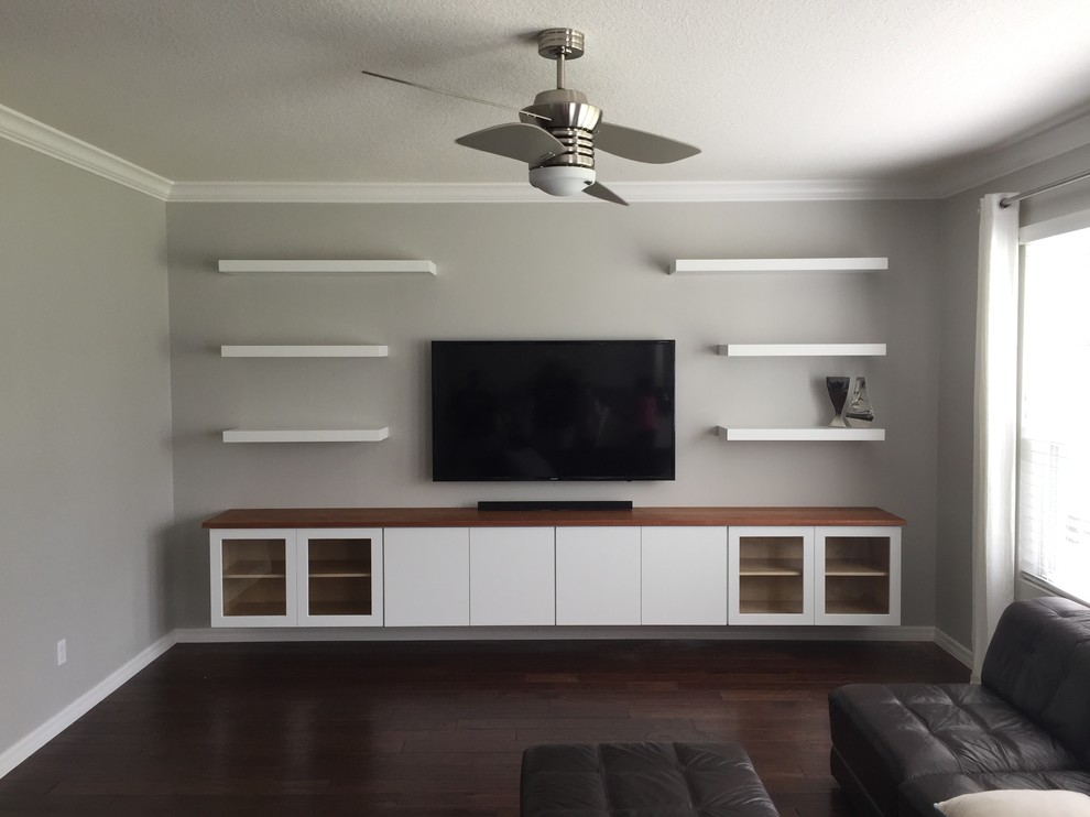 Large minimalist family room photo in Orlando with a wall-mounted tv