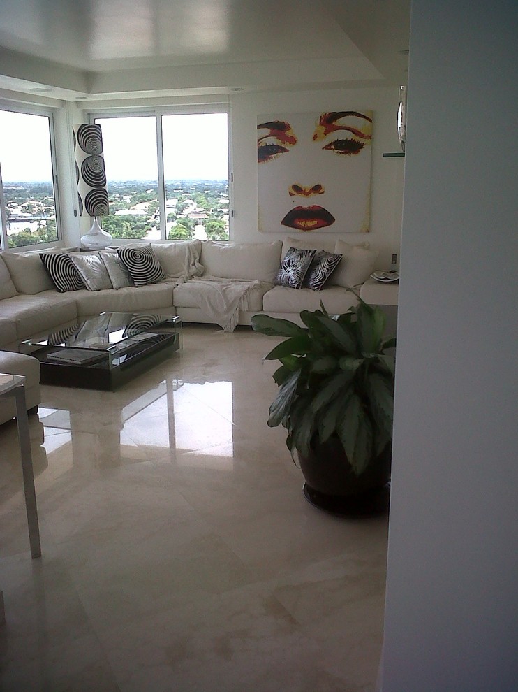 Large contemporary open plan games room in Miami with a game room, white walls and marble flooring.