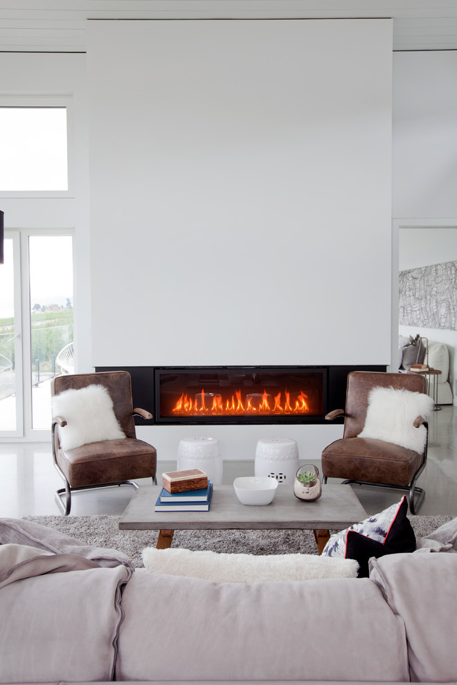 Inspiration for a large contemporary open concept concrete floor family room remodel in Vancouver with white walls, a ribbon fireplace, a plaster fireplace and no tv