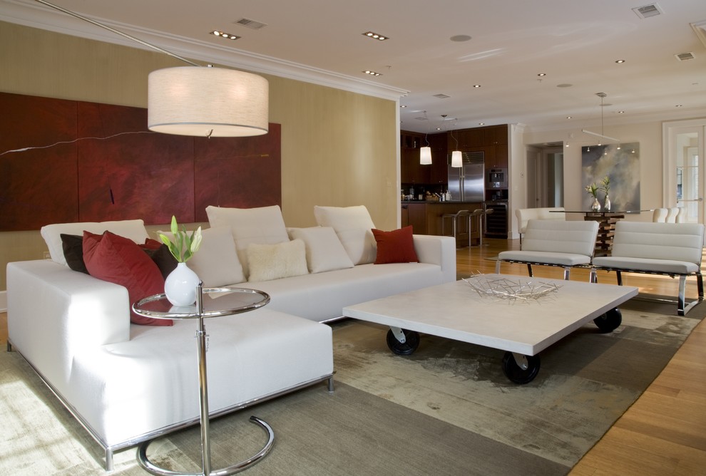This is an example of a contemporary open plan games room in DC Metro with beige walls and light hardwood flooring.