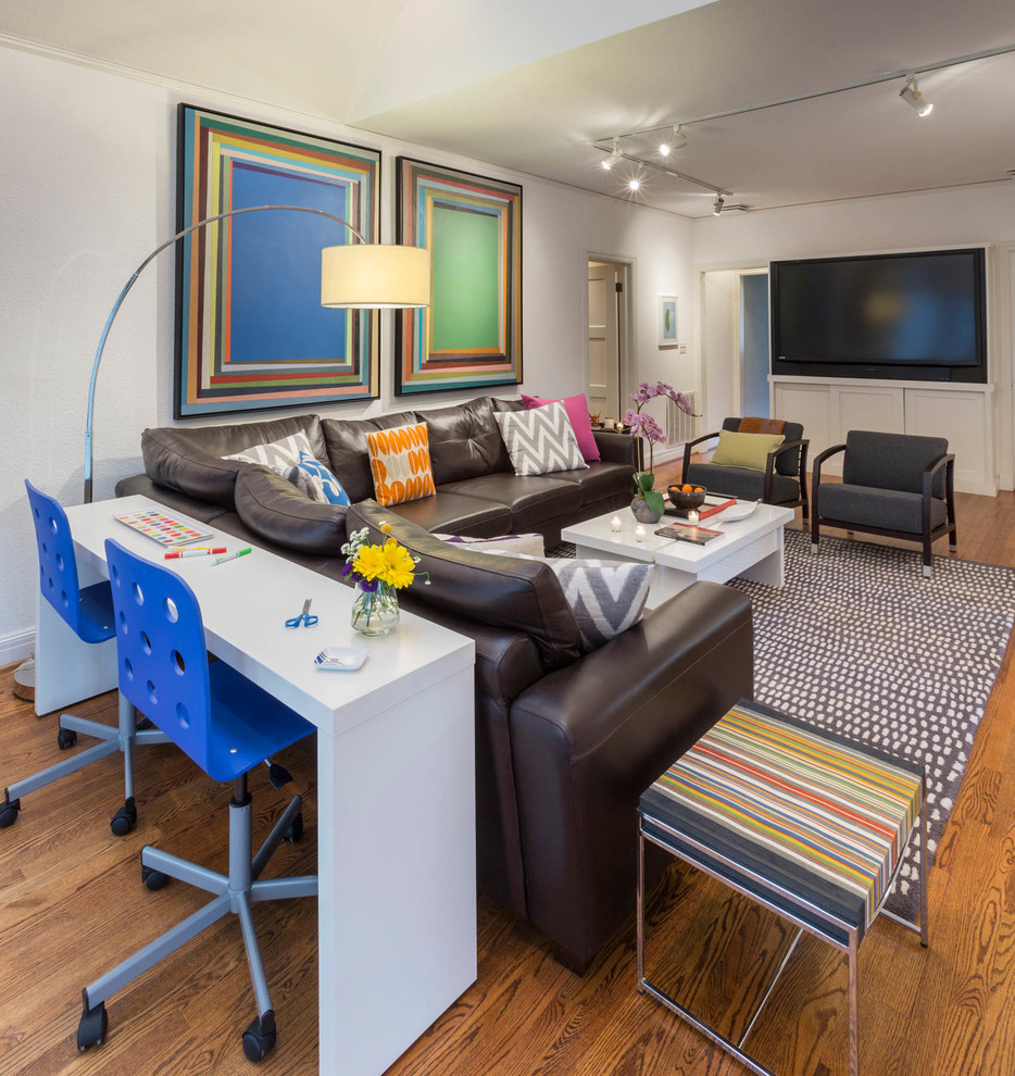 Family room - large eclectic enclosed medium tone wood floor and brown floor family room idea in Dallas with white walls and a media wall