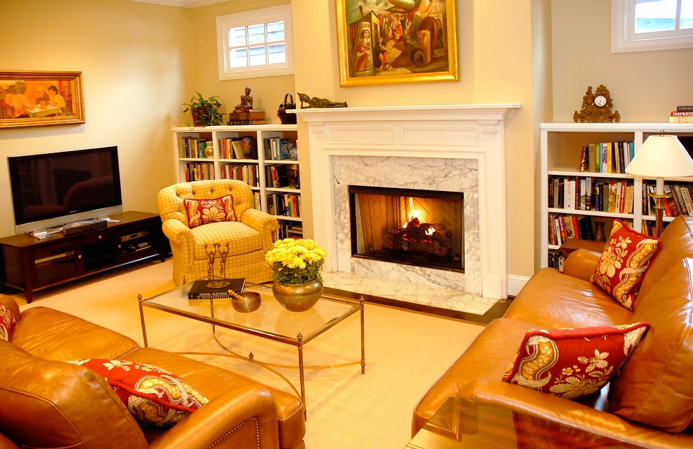 Mittelgroßes, Offenes Stilmix Wohnzimmer mit beiger Wandfarbe, braunem Holzboden, Kamin, Kaminumrandung aus Stein und freistehendem TV in Nashville