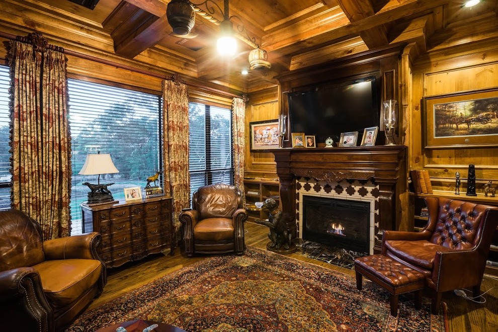 Photo of a medium sized classic enclosed games room in Dallas with brown walls, light hardwood flooring, a standard fireplace, a tiled fireplace surround and a built-in media unit.