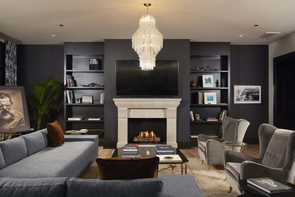 Inspiration for a mid-sized transitional open concept family room remodel in Chicago with black walls, a standard fireplace, a stone fireplace and a wall-mounted tv