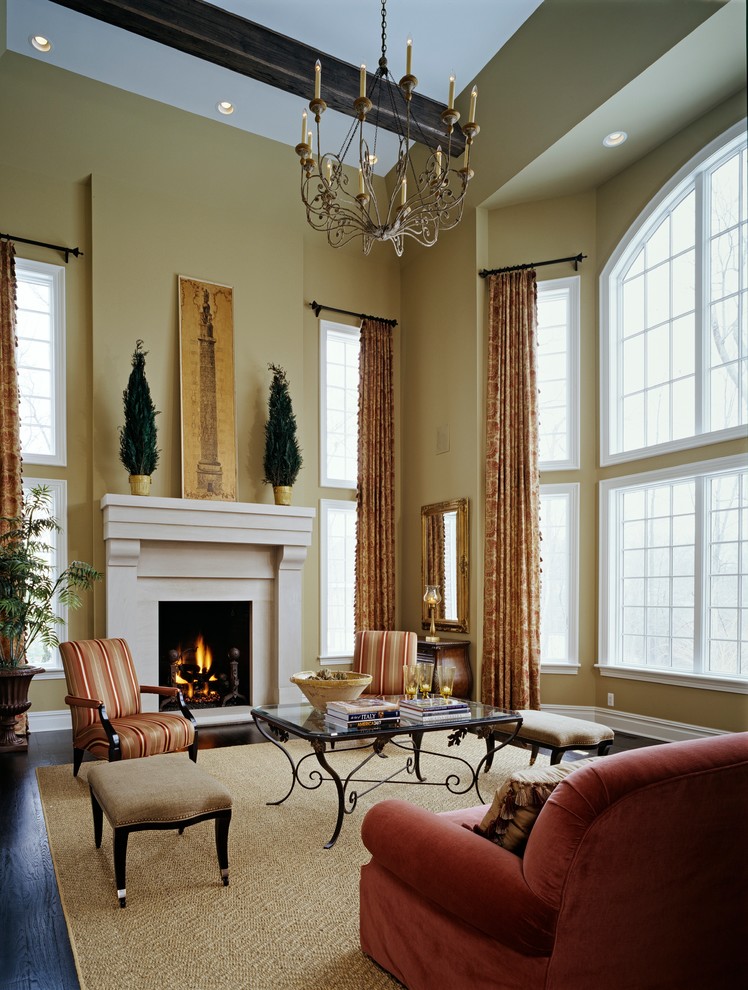 Aménagement d'un très grand salon classique ouvert avec un mur beige, parquet foncé, une cheminée standard et un manteau de cheminée en bois.
