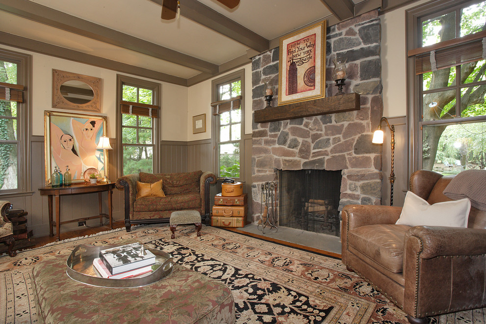 Family room - mid-sized traditional enclosed carpeted and coffered ceiling family room idea in New York with brown walls, a standard fireplace, a stone fireplace and a wall-mounted tv