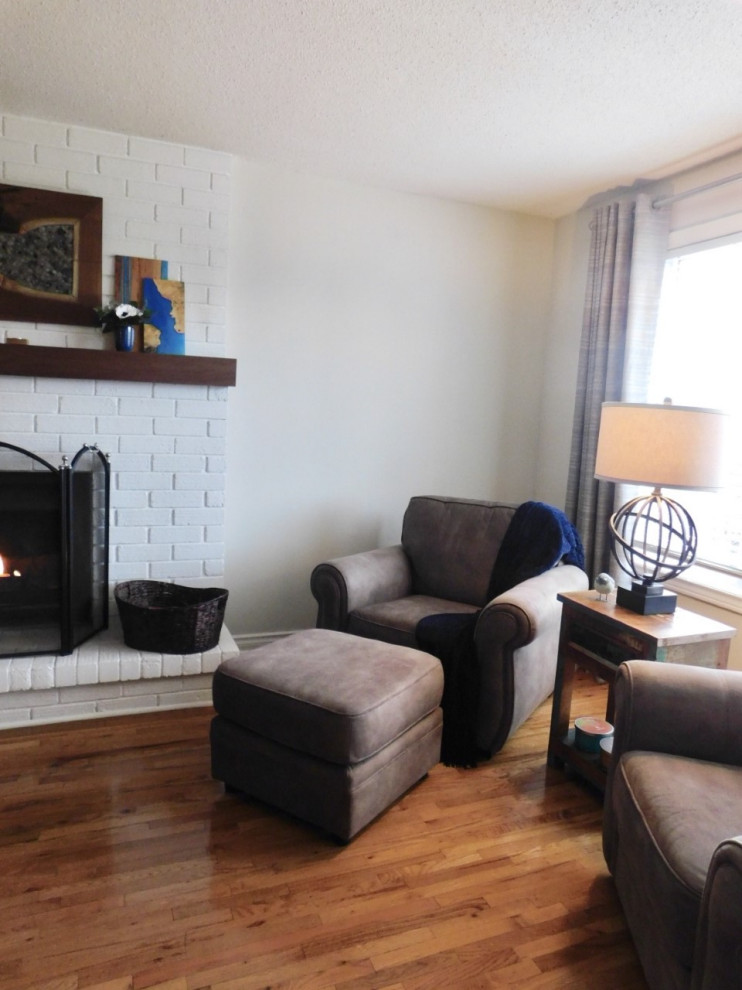Photo of a medium sized country enclosed games room in Toronto with light hardwood flooring, a standard fireplace, a brick fireplace surround, brown floors, green walls and a corner tv.