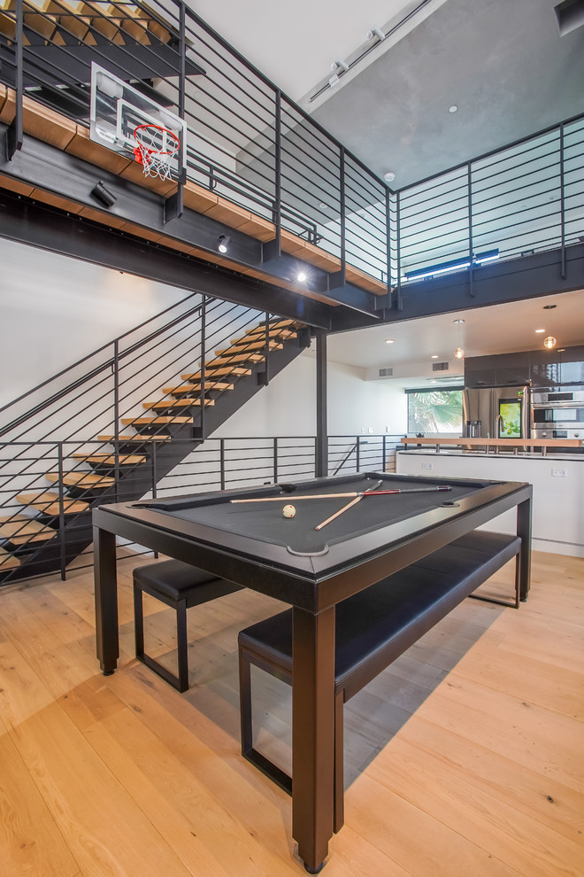 Vintage mezzanine games room in Los Angeles with a game room, white walls, light hardwood flooring and a built-in media unit.