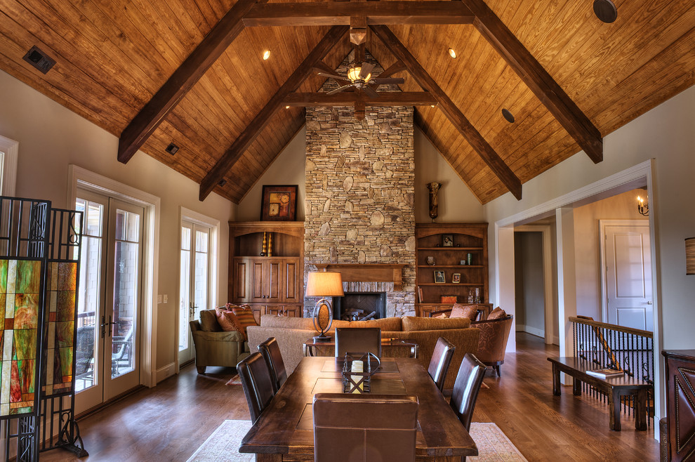 Inspiration for a large timeless open concept medium tone wood floor family room remodel in Other with beige walls, a standard fireplace, a stone fireplace and no tv