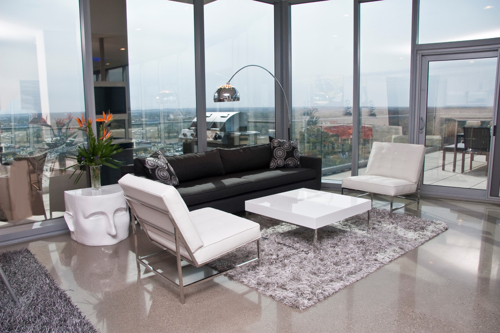 Family room - contemporary concrete floor family room idea in Grand Rapids