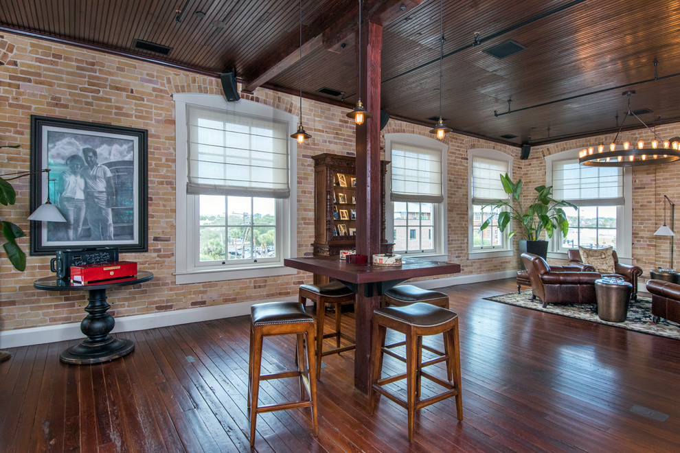 Photo of a traditional open plan games room in Tampa with a home bar, red walls, dark hardwood flooring and brown floors.