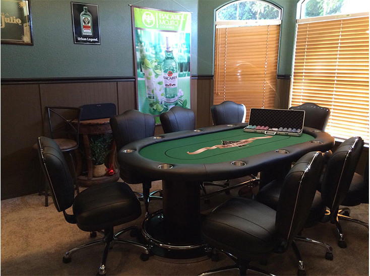 Large contemporary open plan games room in Los Angeles with a game room, a wall mounted tv, green walls and carpet.