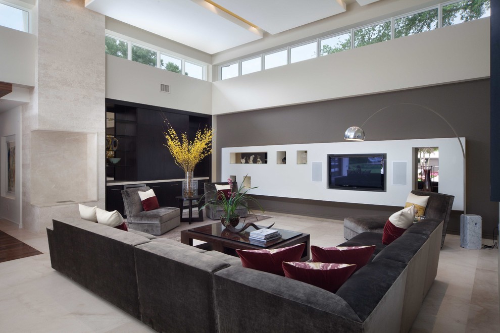 Trendy open concept beige floor family room photo in Orlando with gray walls and a media wall